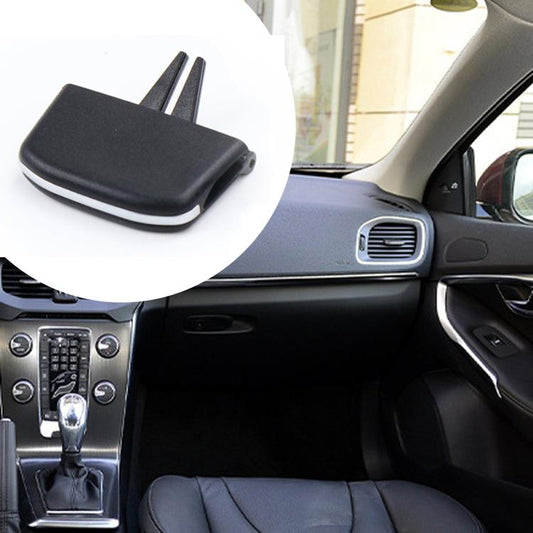Black vent paddle slip cover installed on car dashboard near air vent