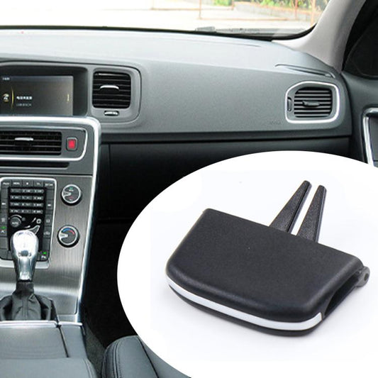 Black air vent paddle insert with two prongs shown beside car dashboard