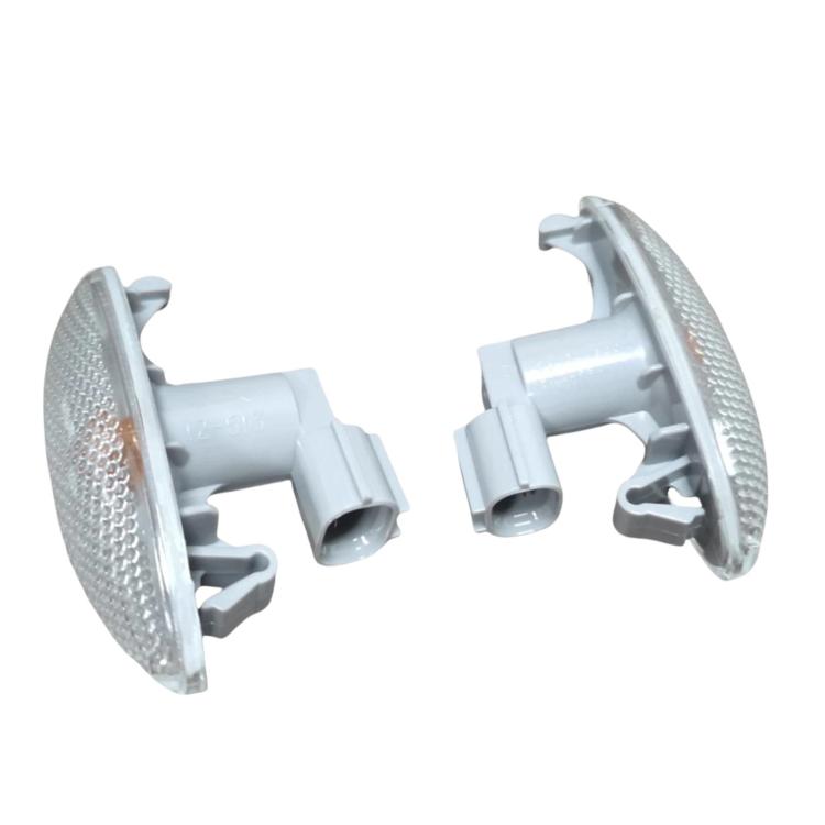 Pair of car turn signal lights with clear textured oval lenses and gray housings