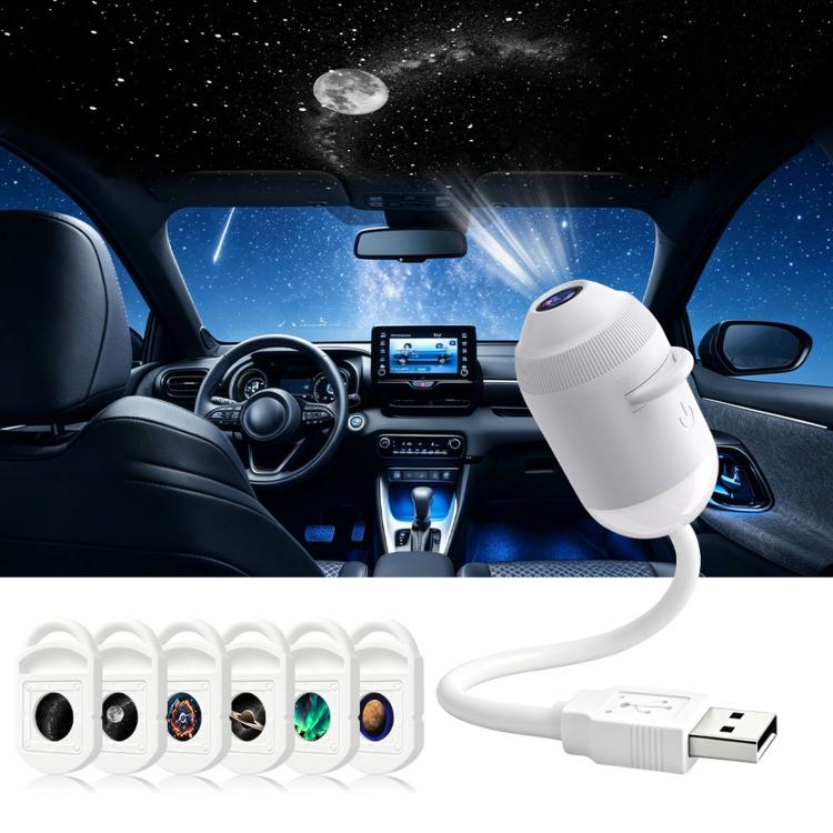 White star projector night light with six lens cartridges and USB cable
