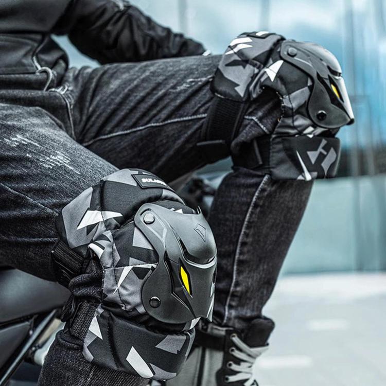 Motorcycle protective pads, black/gray camo with yellow accents, on rider arms and legs