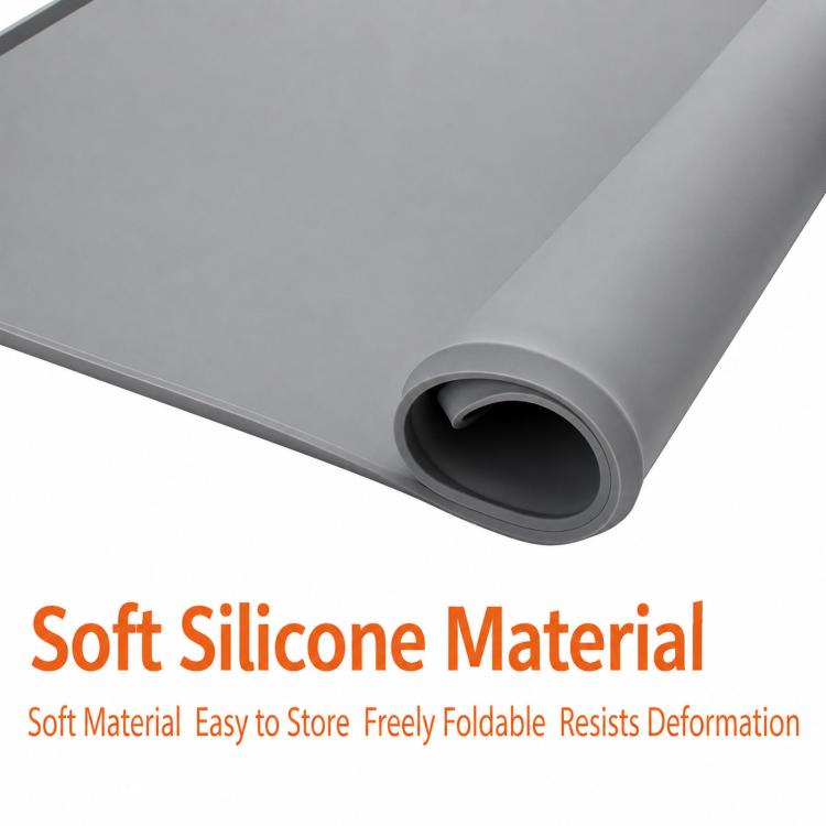 Rolled gray silicone countertop mat showing flexible thickness and curved edge