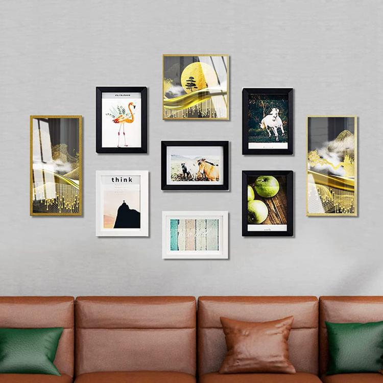 Multiple picture frames hung neatly using sawtooth picture hanging hooks