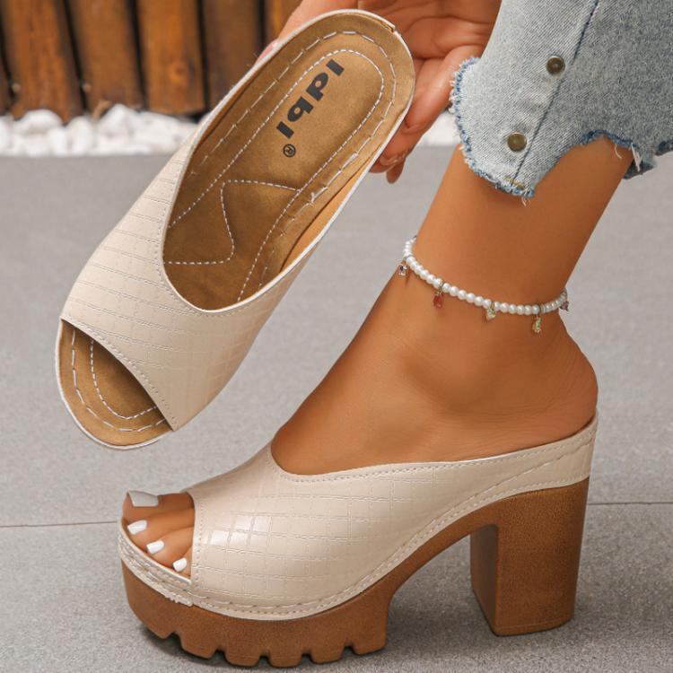 Beige peep-toe platform mule sandal with chunky block heel, shown in hand