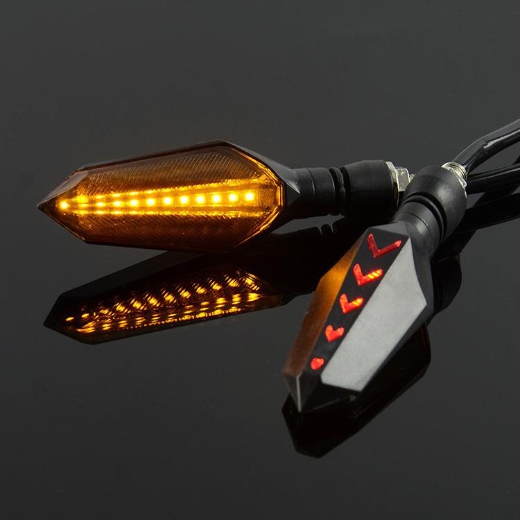Motorcycle LED turn signal pair with flowing amber sequential arrow lights and silver-gray accents