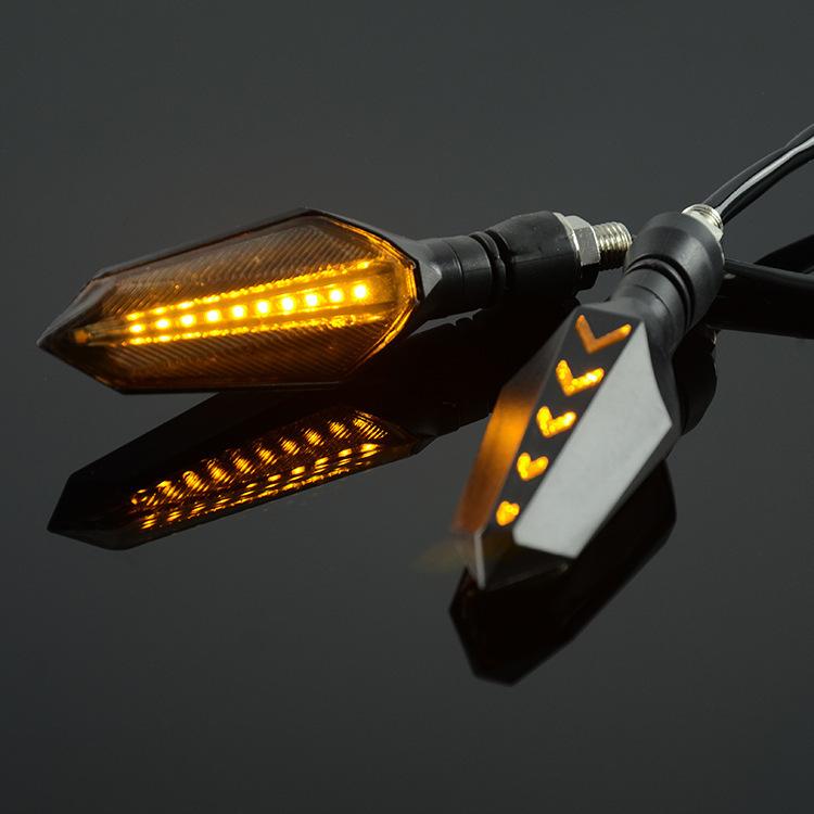 Motorcycle LED turn signal pair with amber sequential arrow LEDs and textured lens housing