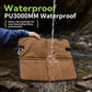 Brown waterproof camping seat pad with carabiner, shown with water splashes on surface