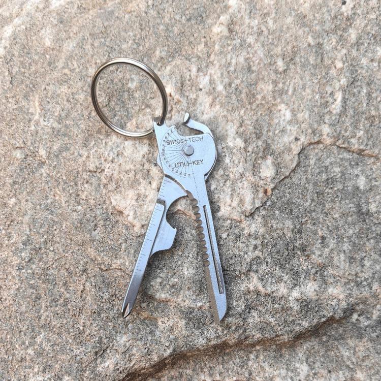 Key-shaped multitool keychain with key ring, blade, and bottle opener tool