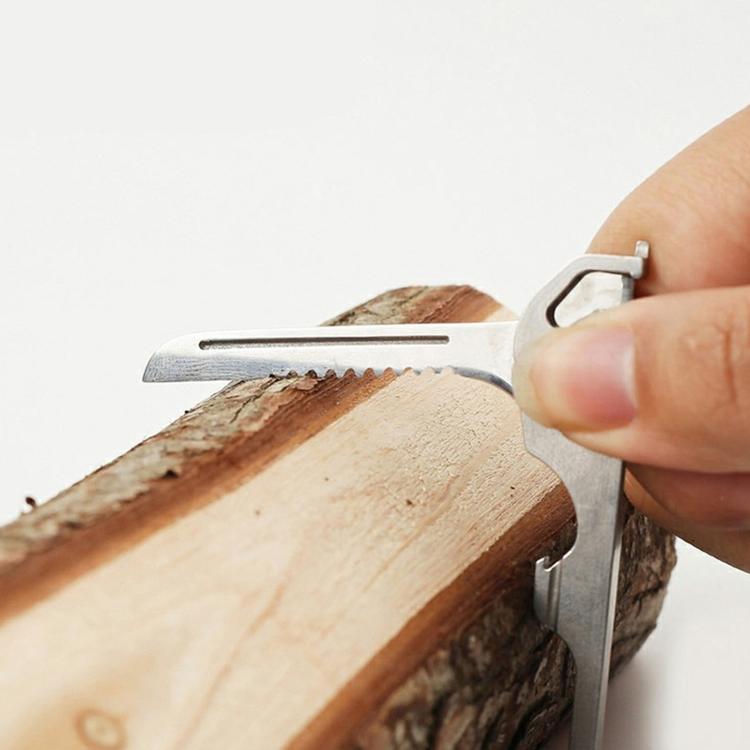 Key-shaped multitool keychain sawtooth blade cutting into wood