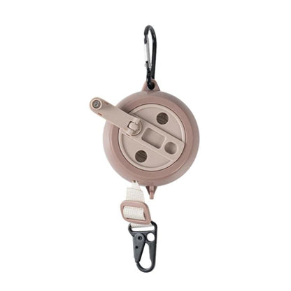 Retractable clothesline reel with beige housing, webbing strap, and carabiner hook