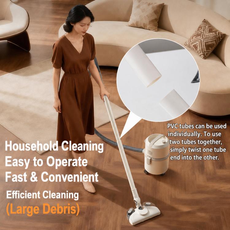 Corded canister vacuum with mop head and hose, in use on indoor floor near sofa