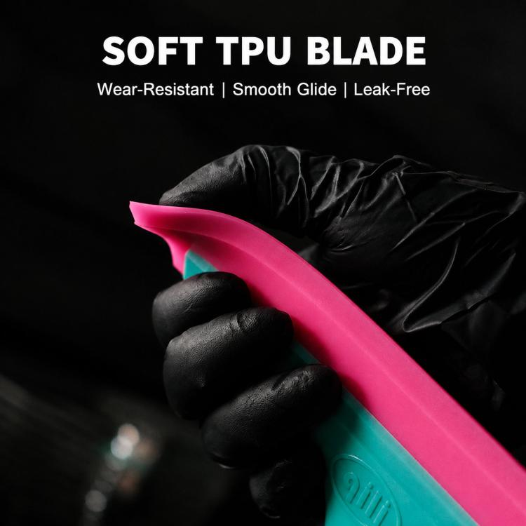Soft TPU-style pink blade window squeegee with teal body, held in a gloved hand