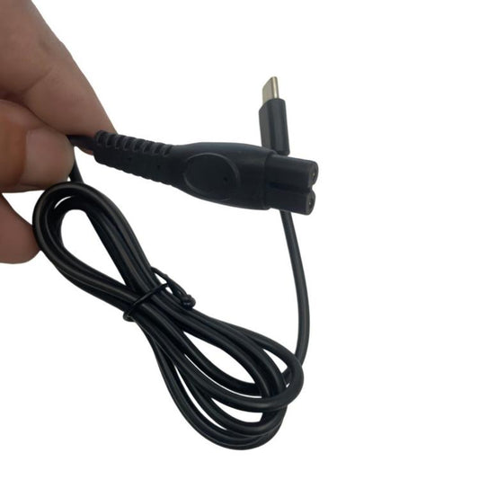 Black shaver charging cable with USB-C plug and shaver connector, close-up