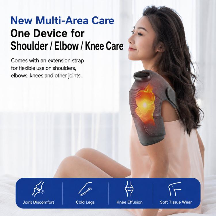 Gray cordless heated massager sleeve on upper arm with controller and heat glow