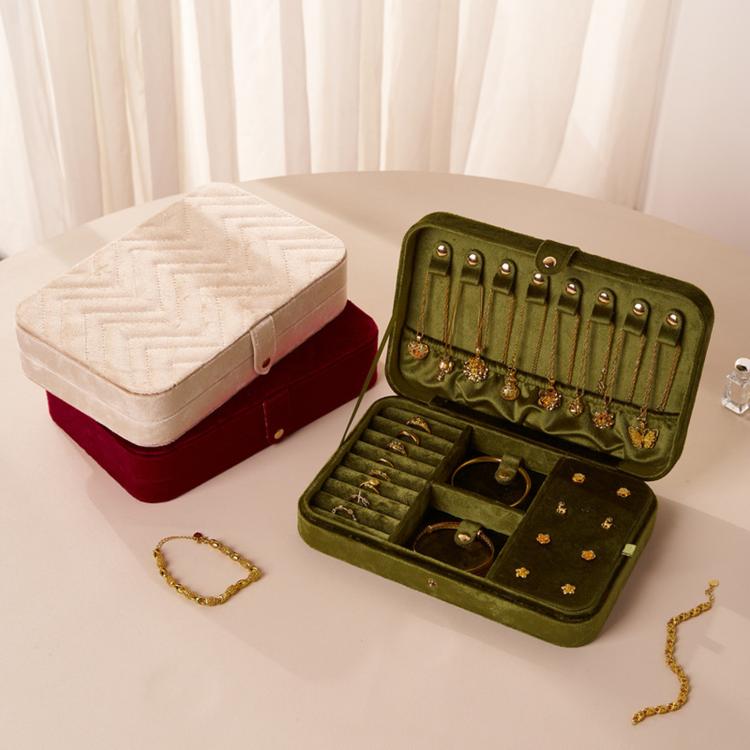 Set of velvet jewelry organizers in cream and green, both with hinged lids and compartments