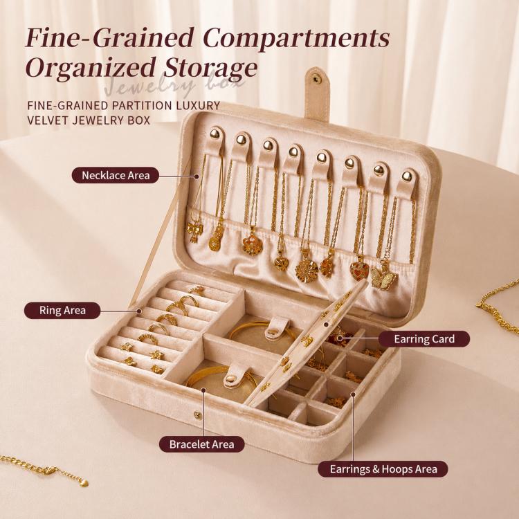 Beige velvet jewelry box open with organized compartments for rings, bracelets, and earrings