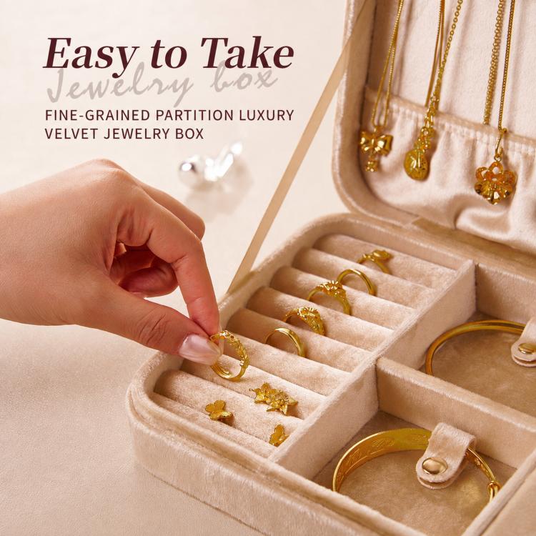 Beige velvet jewelry box interior with compartments as a hand places a ring