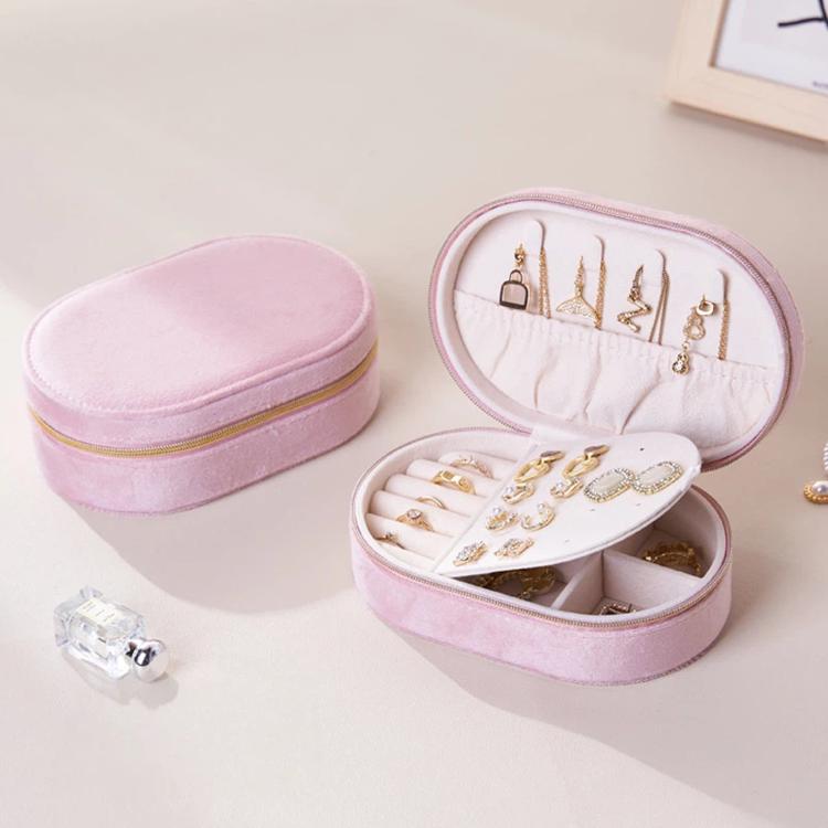 Pink velvet oval jewelry case with zipper, open compartments and earring stud board
