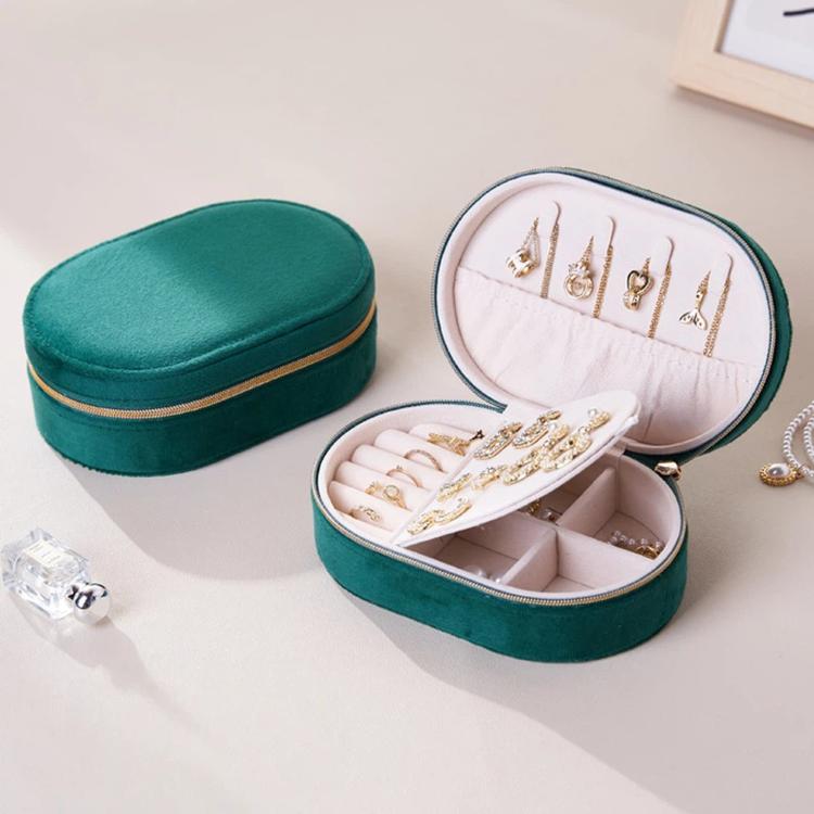 Green velvet oval jewelry case with zipper, open base trays and earring stud panel