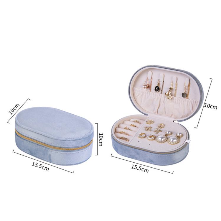 Light blue velvet oval jewelry case with zipper, open earring stud board and compartments