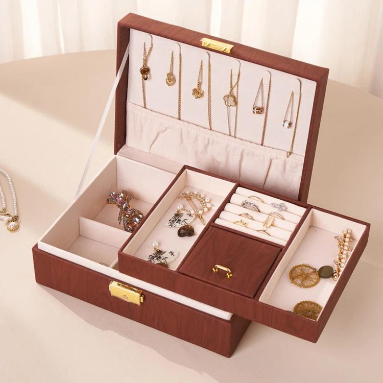 Brown wood-grain jewelry box open with divided compartments for rings and necklaces