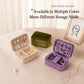Velvet travel jewelry boxes in multiple colors, including green, purple and cream beige