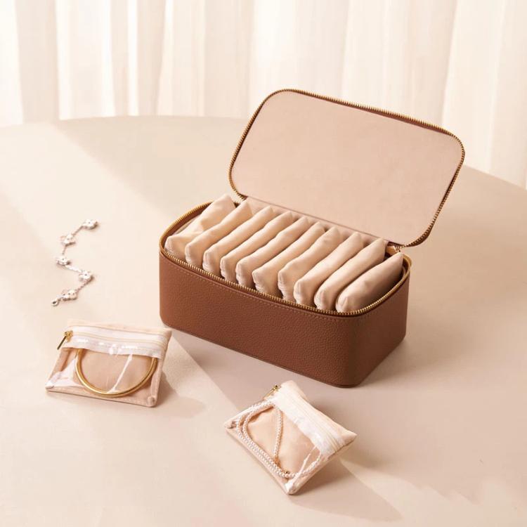 Brown PU jewelry organizer case with open lid and 12 clear zip pouches inside