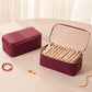 Wine red PU jewelry storage case with open lid and beige insert plus 12 zip pouches