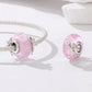 Silver charm bracelet with pink glass bead featuring an angel figure