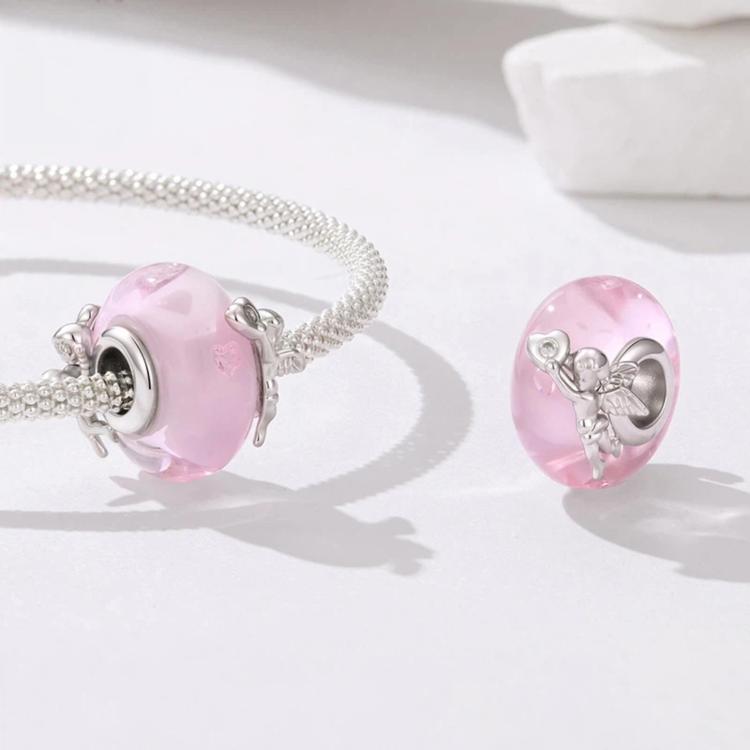 Silver charm bracelet with pink glass bead featuring an angel figure