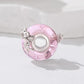 Pink glass DIY bead with silver angel charm and circular center hole