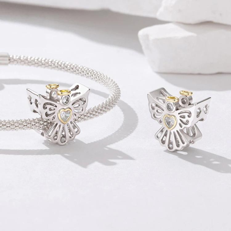 Two silver angel charm beads with heart gems and gold accent rings