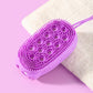 Purple oval silicone body scrubber with small bristle tips on a bath sponge backing.