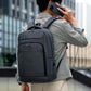 REMOID slim business laptop backpack worn on back, gray straps and front pocket.