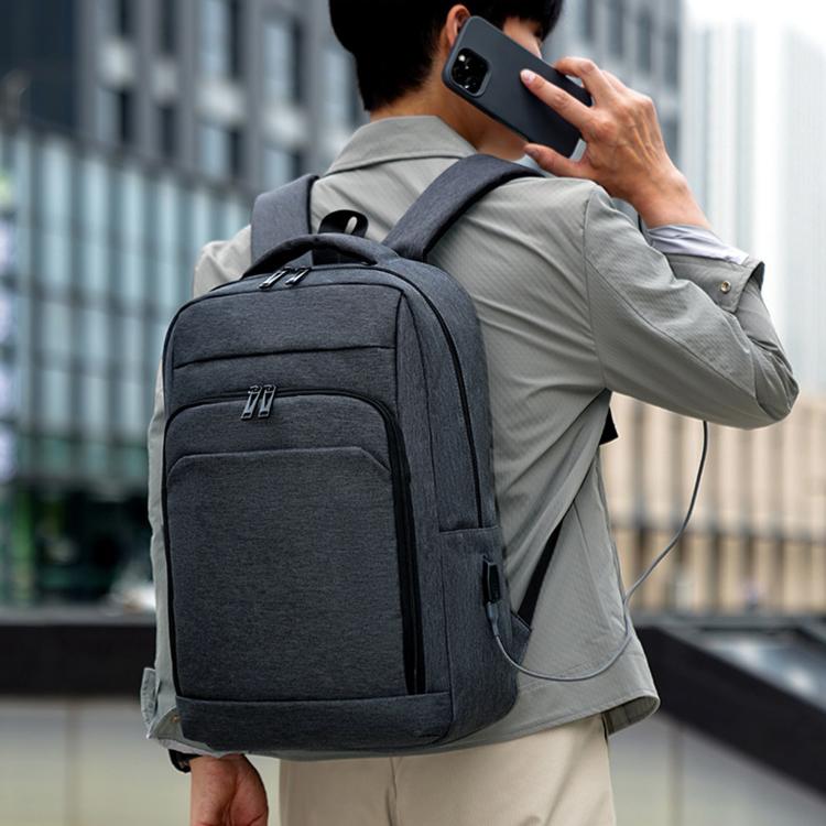 REMOID slim business laptop backpack worn on back, gray straps and front pocket.
