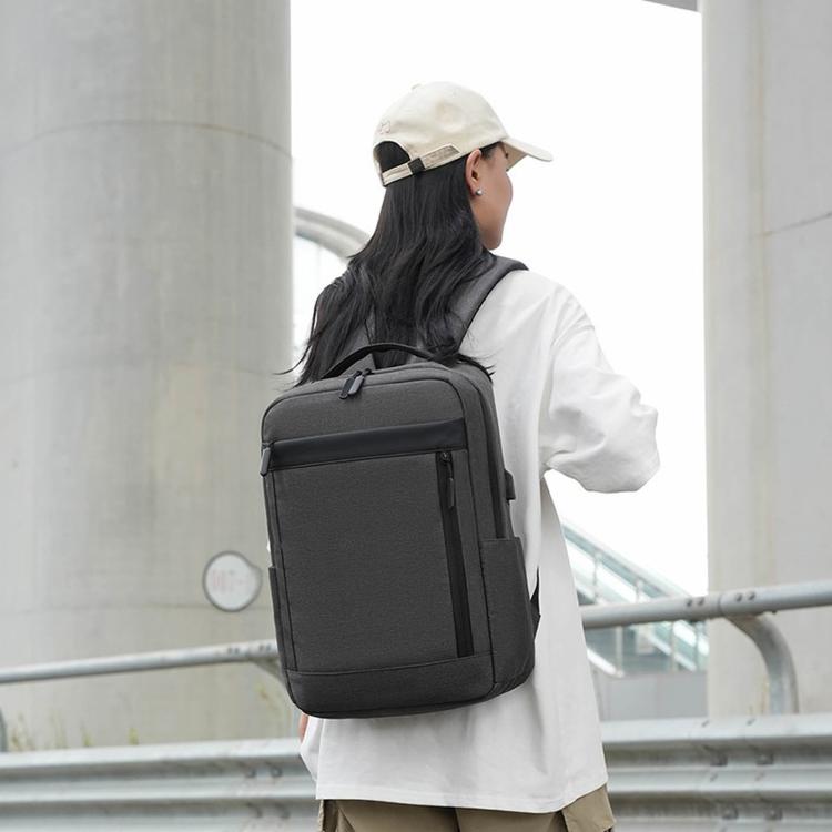 Dark gray laptop backpack with front zip pocket, side profile, adjustable shoulder straps