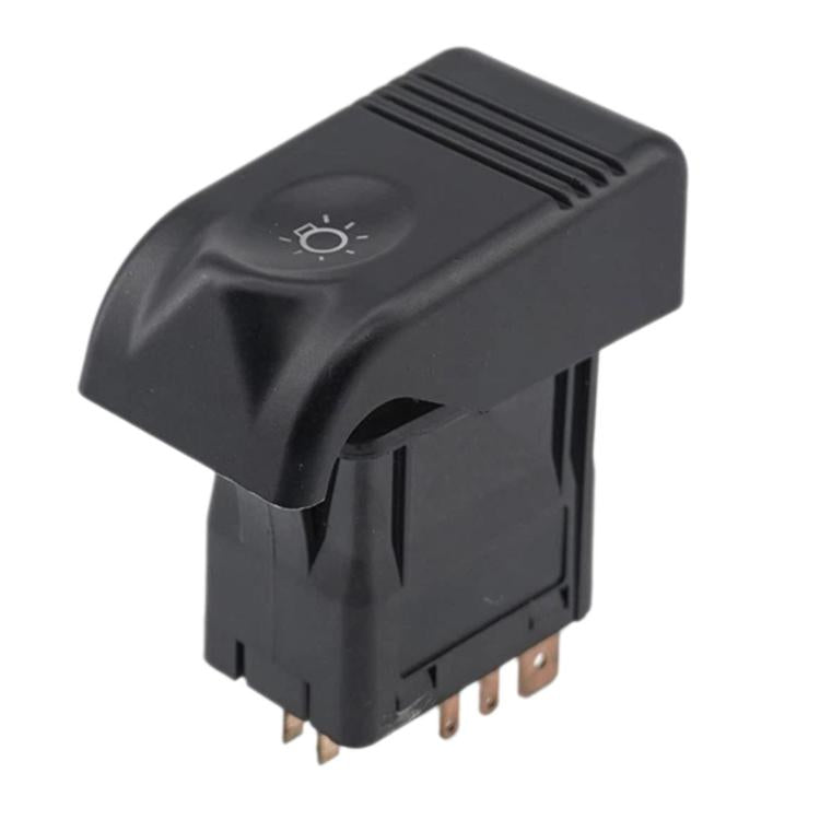 Black headlight control switch with headlight icon on top and metal pins on bottom