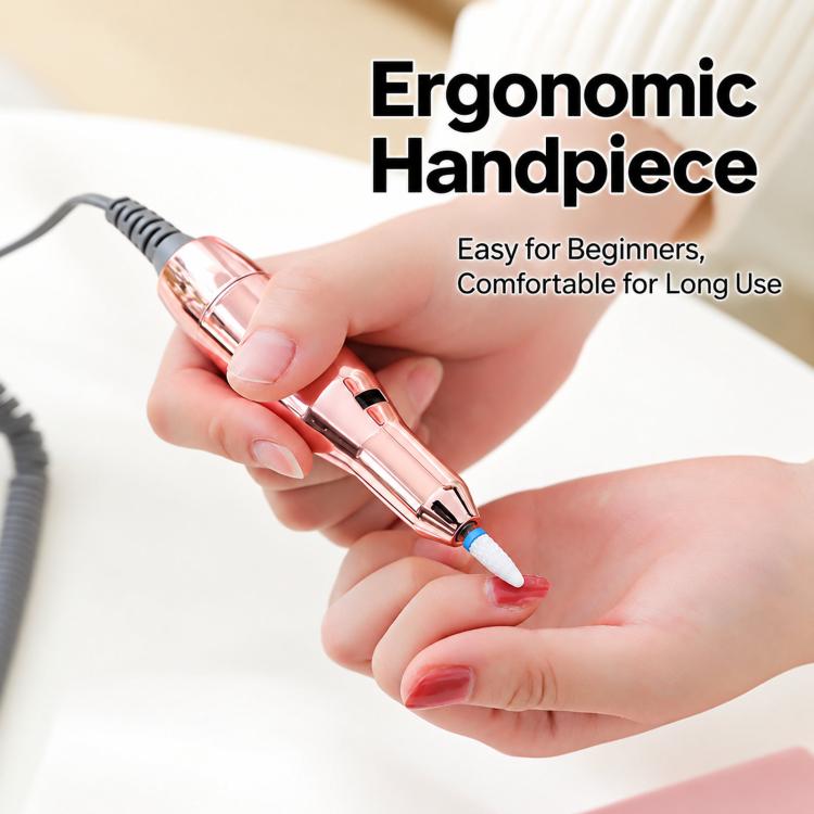 Rose-gold electric nail drill handpiece held for nail filing, with power cable