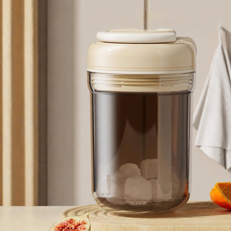 Beige portable ice press cup with lid; clear container shows ice blocks