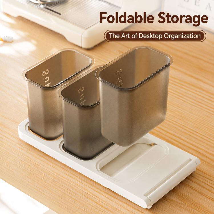 Foldable white base with three dark-toned bins for desktop capsule and snack storage