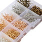 Close-up of clear organizer compartments filled with gold, silver, and bronze jump rings