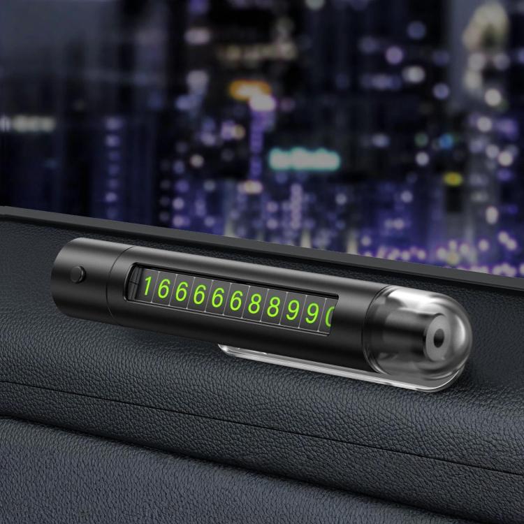 Black car safety hammer with flip-out parking number plate on a dashboard