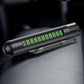 Dark gray car safety hammer with flip-out parking number plate on a seat