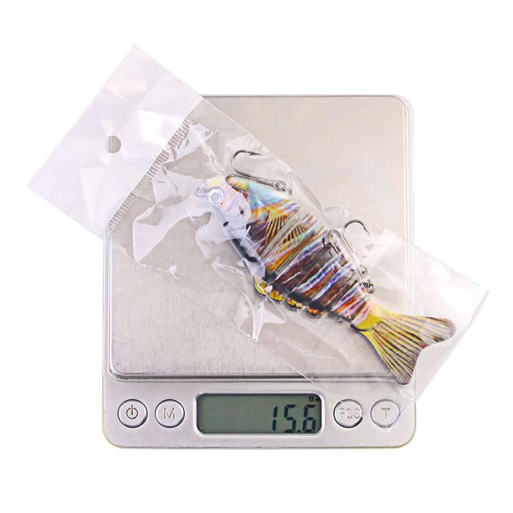 Multi-segment hard fishing swimbait lure on digital weight scale
