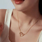Gold-tone heart pendant necklace worn with cable chain on neckline