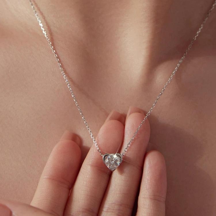Close-up of sterling silver heart-shaped moissanite pendant on a chain necklace