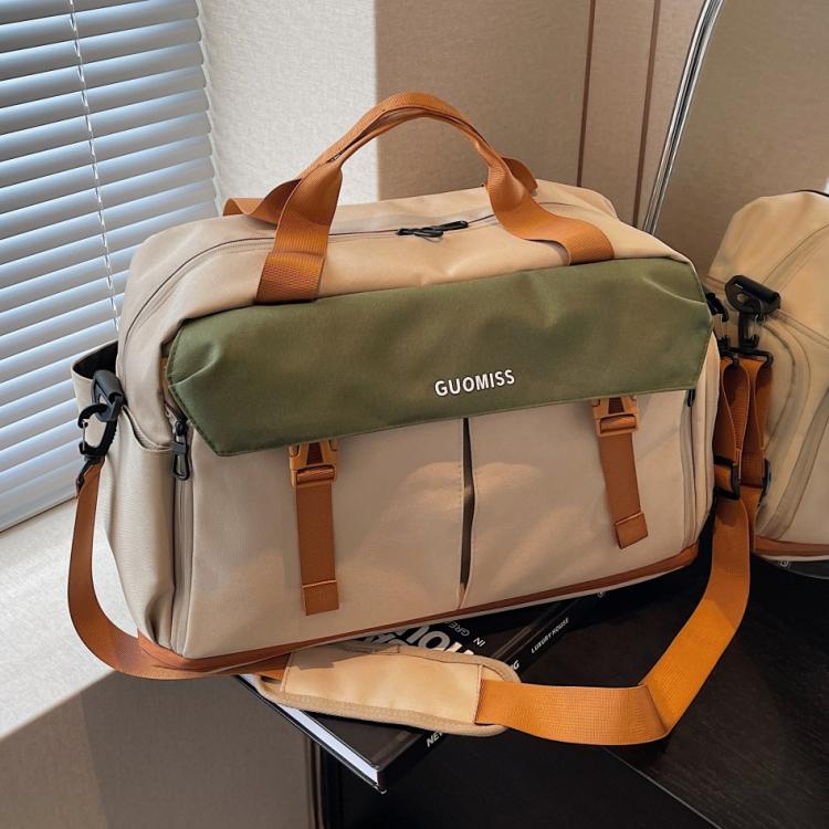 Khaki and dark green travel duffel bag with orange handles and front zip pocket