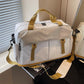 Cream travel duffel bag with yellow-brown handles and front zipper pocket