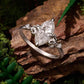 Sterling silver teardrop moissanite ring shown from the side with prong details