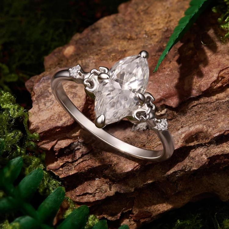 Sterling silver teardrop moissanite ring shown from the side with prong details